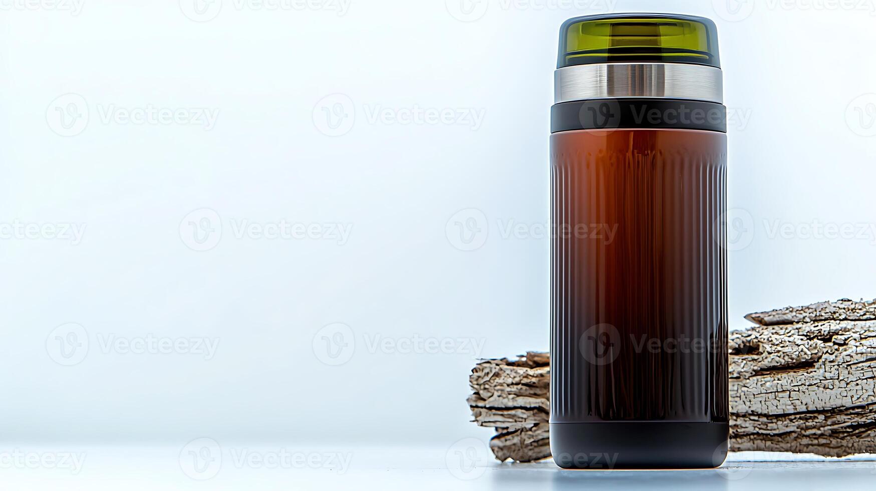 Stylish insulated beverage container resting on textured wooden surface against a light backdrop photo