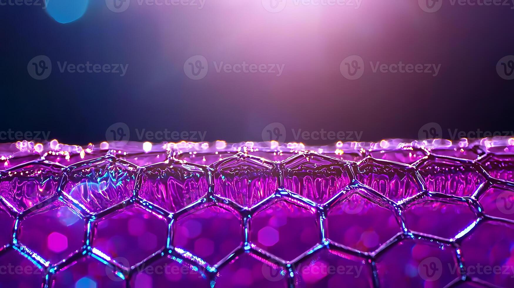 Close-up of a vibrant honeycomb structure with reflections and colorful bokeh background photo