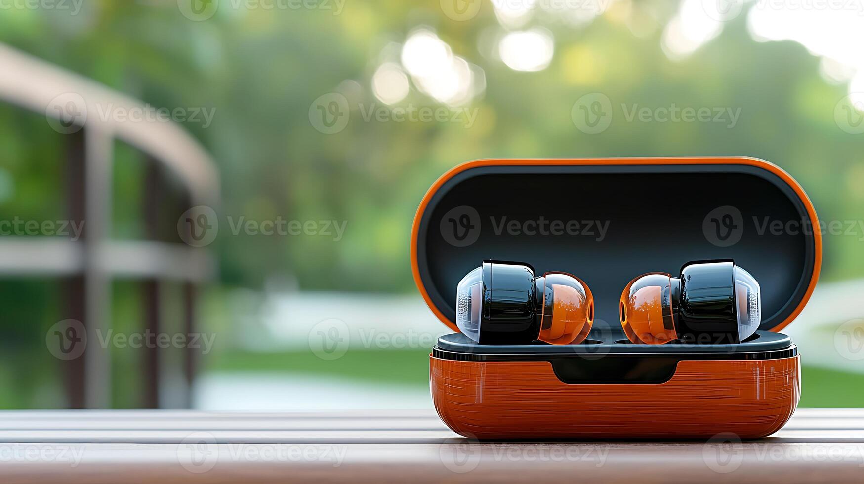 Close-up of wireless earbuds in their case on a wooden surface with a blurred green background photo