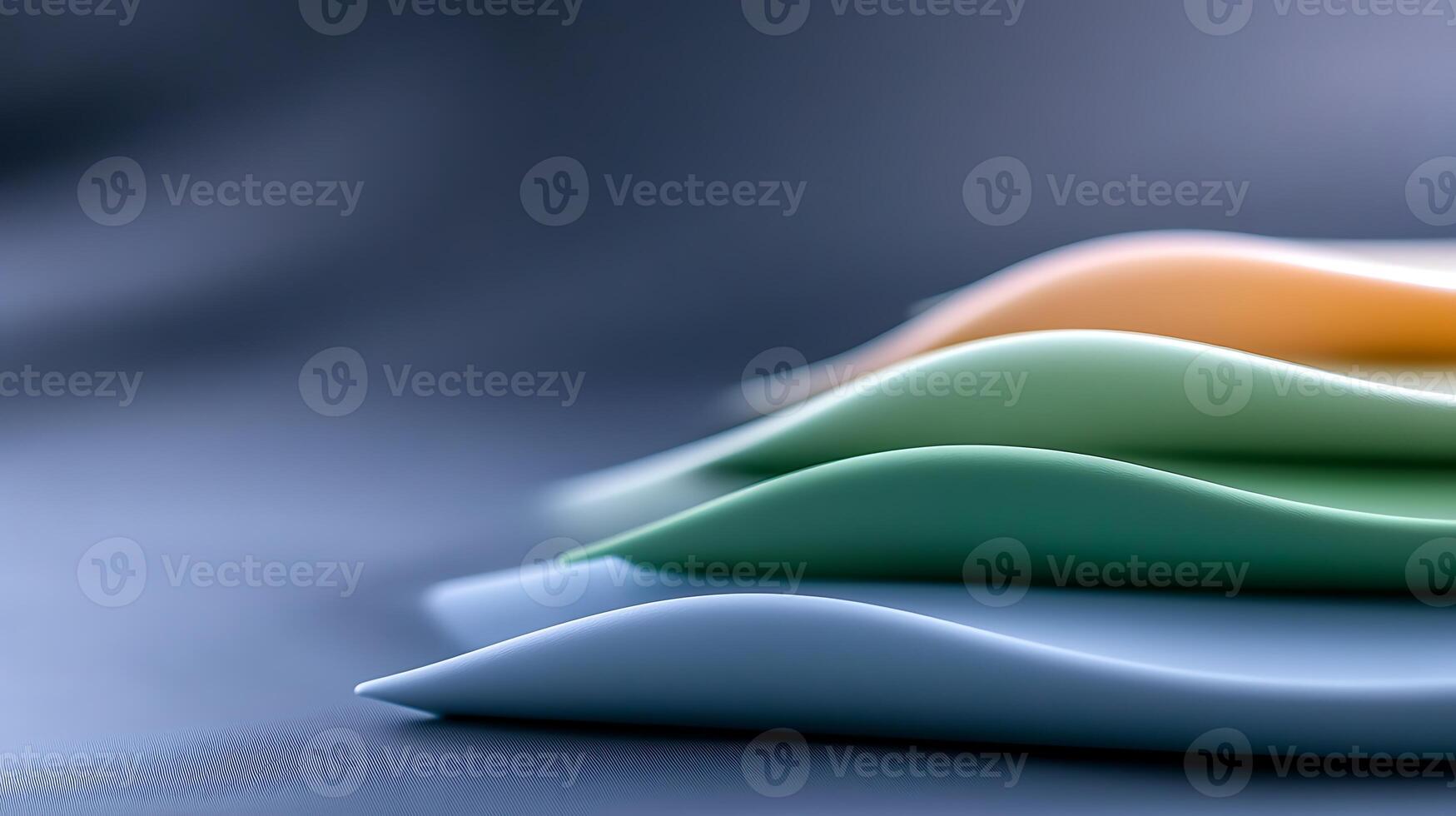 Close-up of colorful, wavy silicone sheets stacked on a smooth surface with soft lighting photo