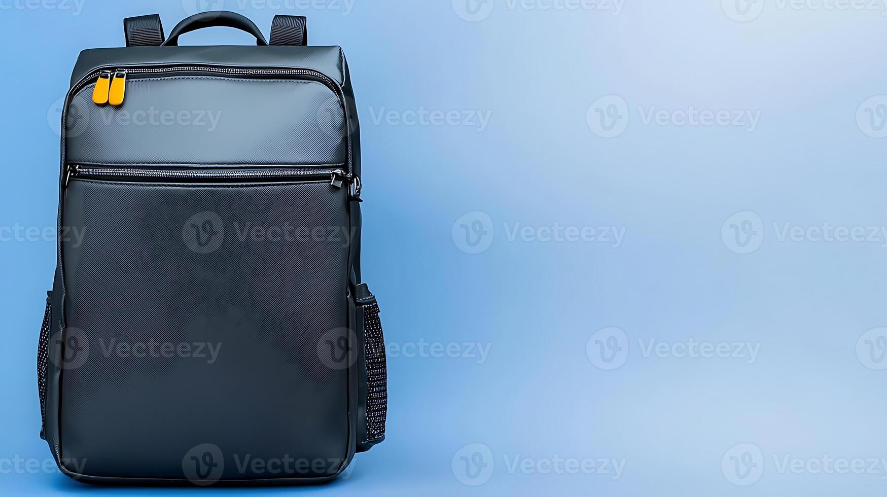 Sleek black backpack against a soft blue background, showcasing minimalist design and functionality photo
