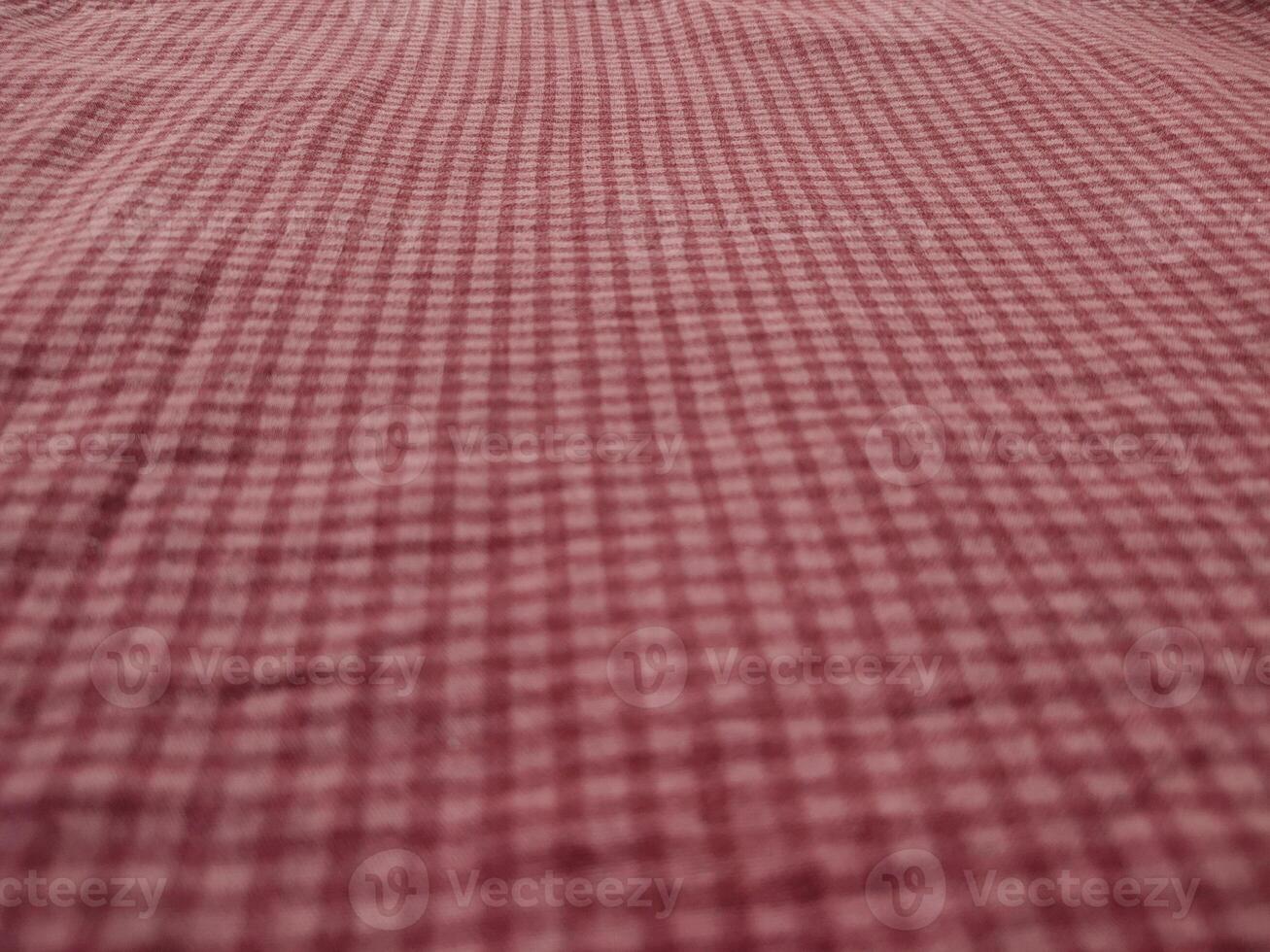 a bed with a red and white checkered sheet photo