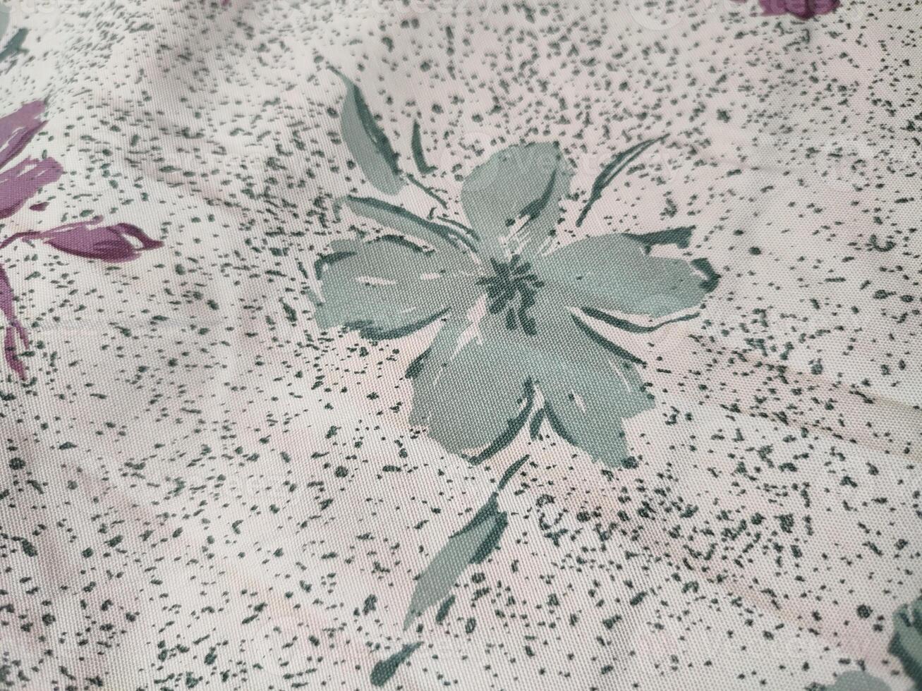 a close up of a floral pattern on a white bedspread photo