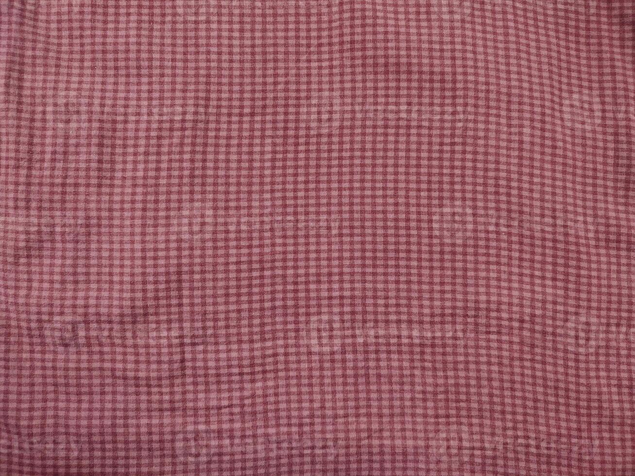 a pink and white checkered fabric with a white border photo