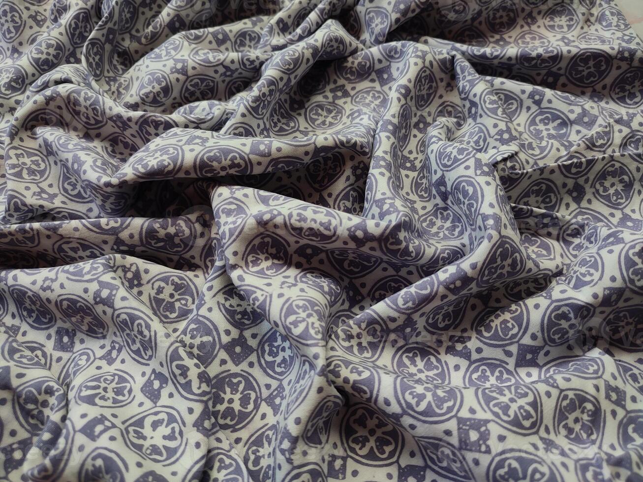 a purple and white fabric with a pattern photo