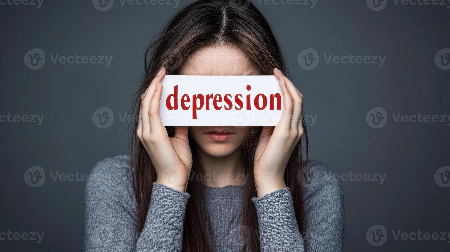 woman with long hair holds sign reading depression over her eyes, conveying sense of emotional struggle. background is dark, emphasizing somber mood photo