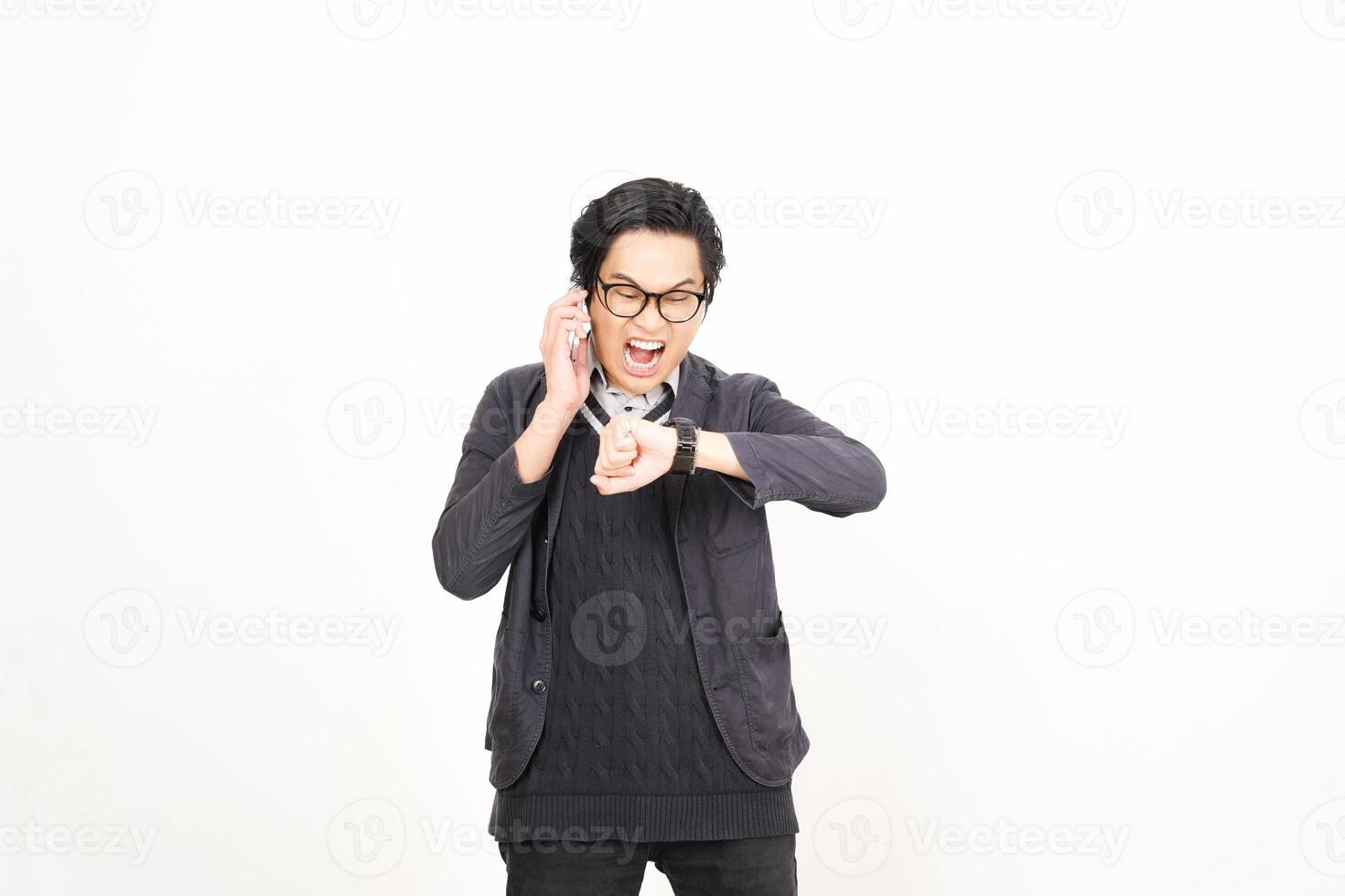 A man in glasses and a sweater is making a phone call photo