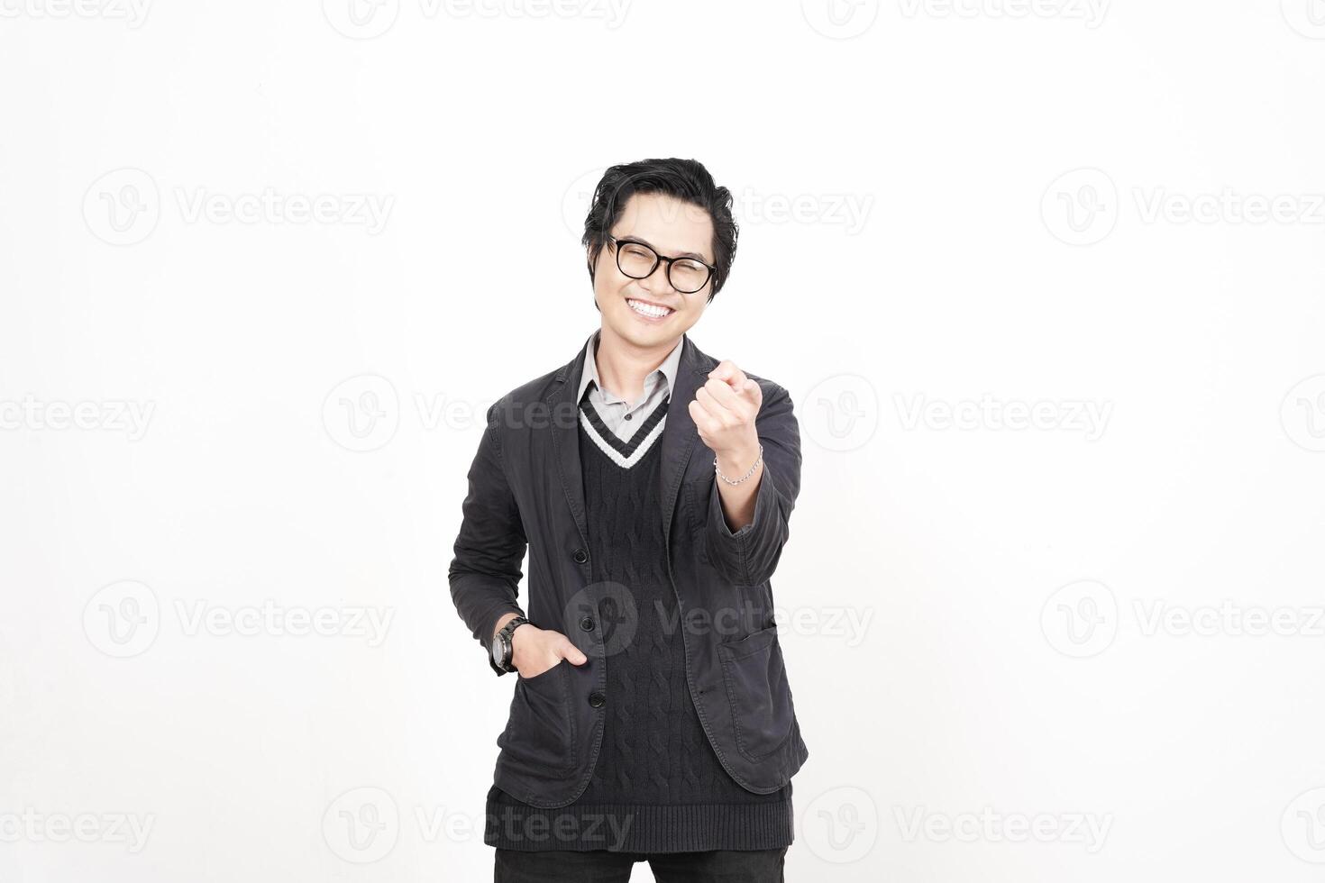 A man in glasses and a sweater is pointing at something photo
