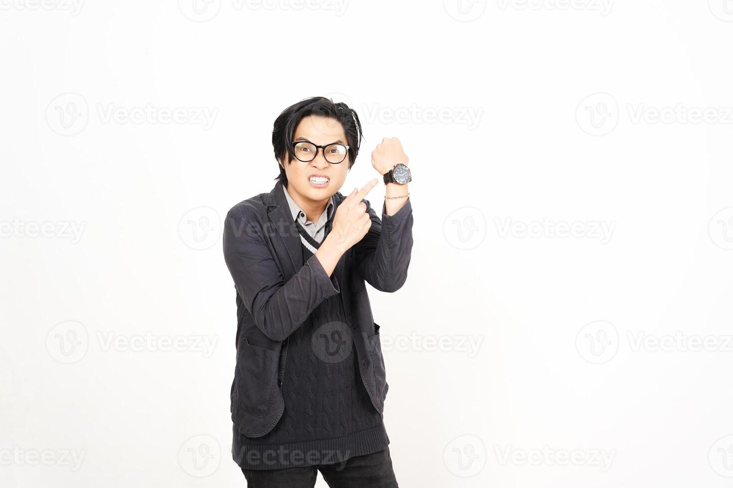 A man in glasses and a sweater is holding his wrist photo