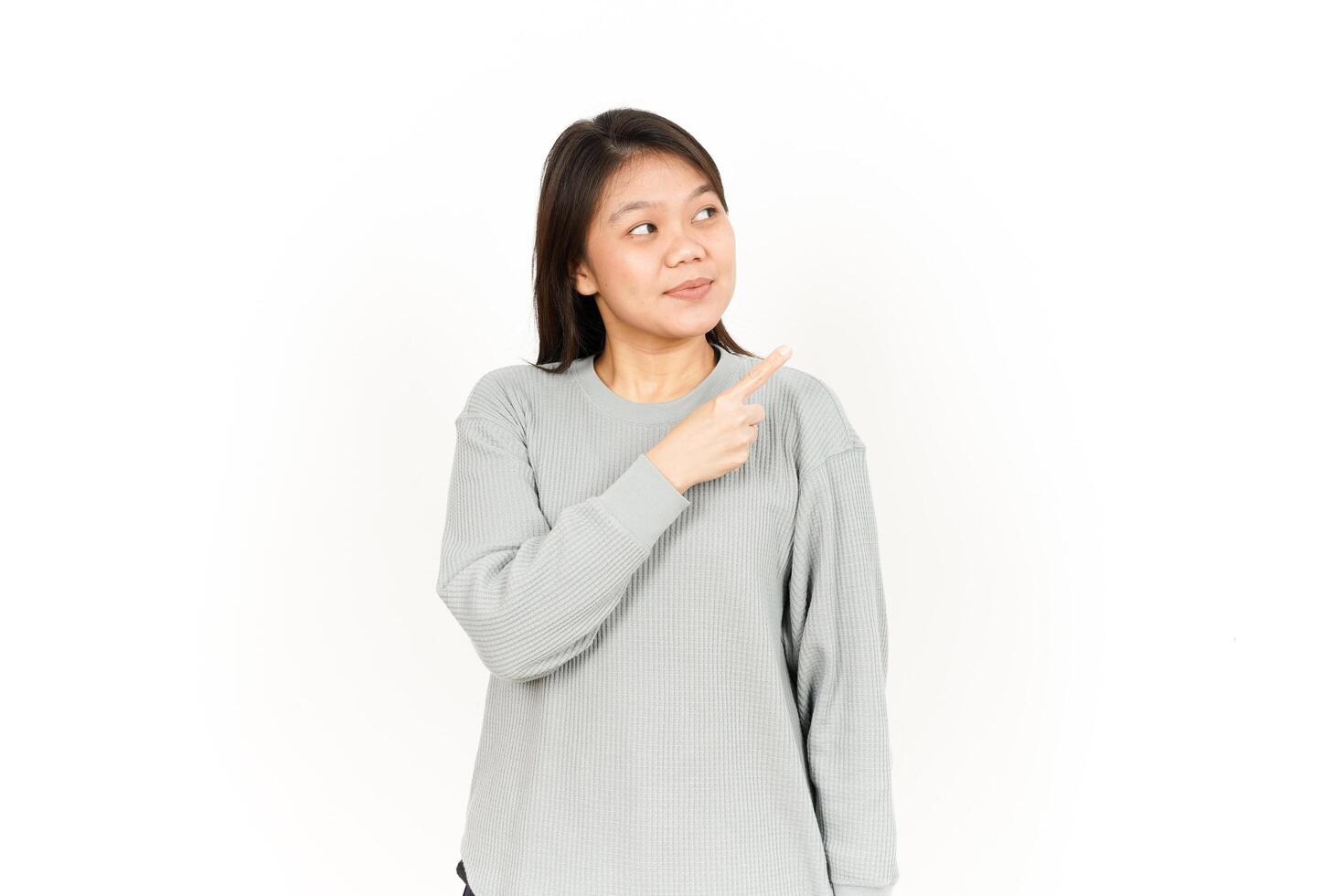 A woman pointing to her side with her finger photo