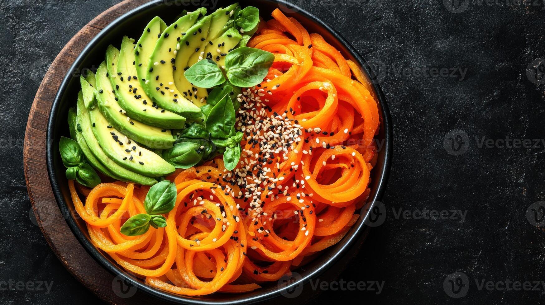 A bowl of vegetables with avocado and carrots photo