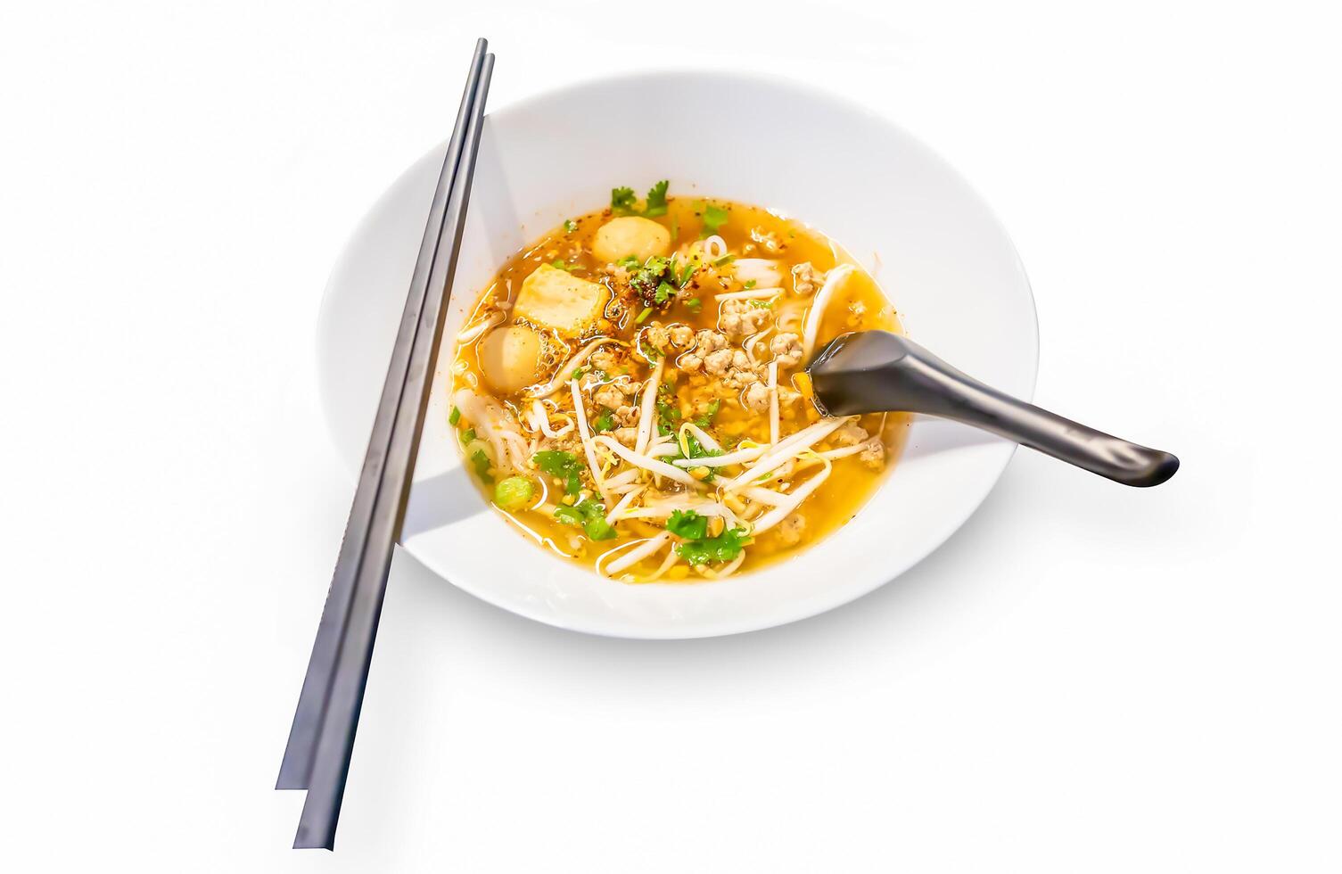 Top view of Spicy TOM YAM pork noodle soup with lemongrass chilly pasted and lime juice, focus selective photo