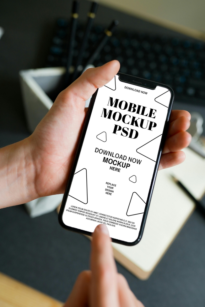 Mobile Phone Mockup in Hand Showing a Clean Interface on a Desk psd