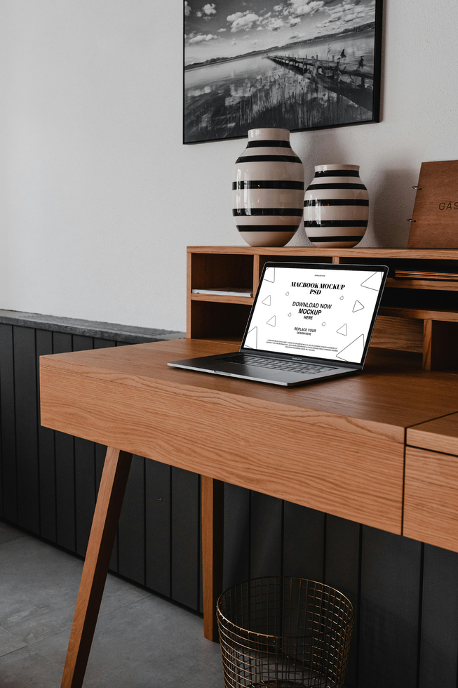Elegant wooden desk with laptop and decor mockup psd