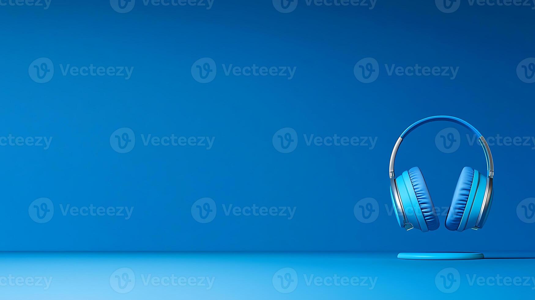 Stylish blue headphones displayed on a minimalistic blue background, emphasizing modern design photo