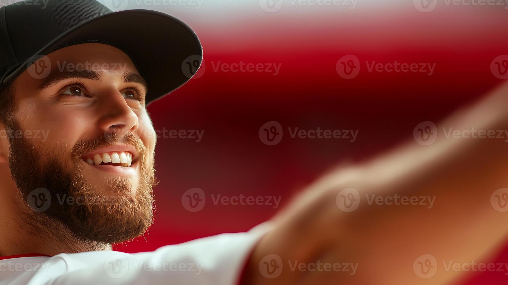 Smiling baseball player in action, showcasing enthusiasm during a game with blurred crowd background photo