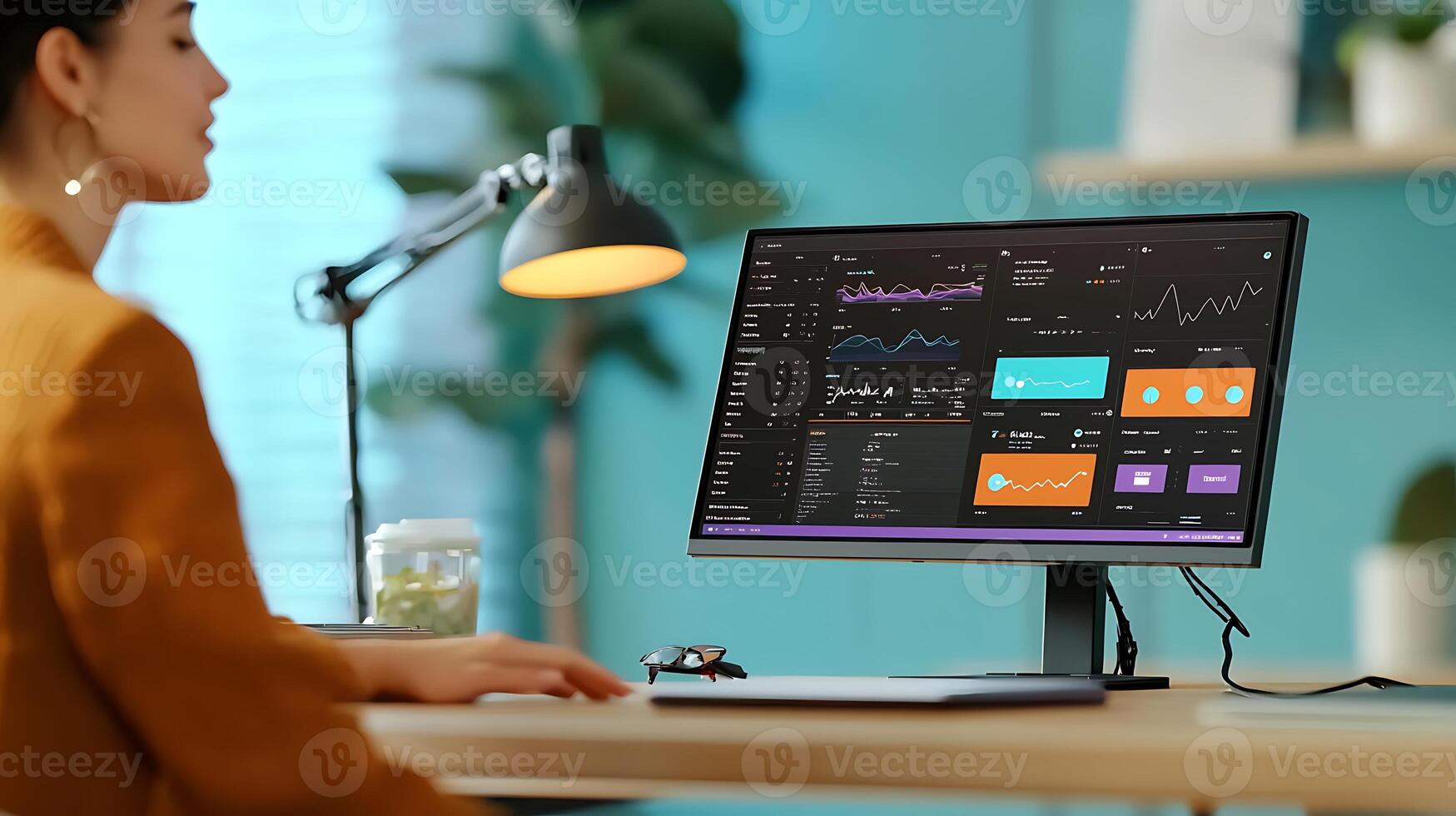 Woman analyzing data on a modern computer screen in a bright office with plants photo