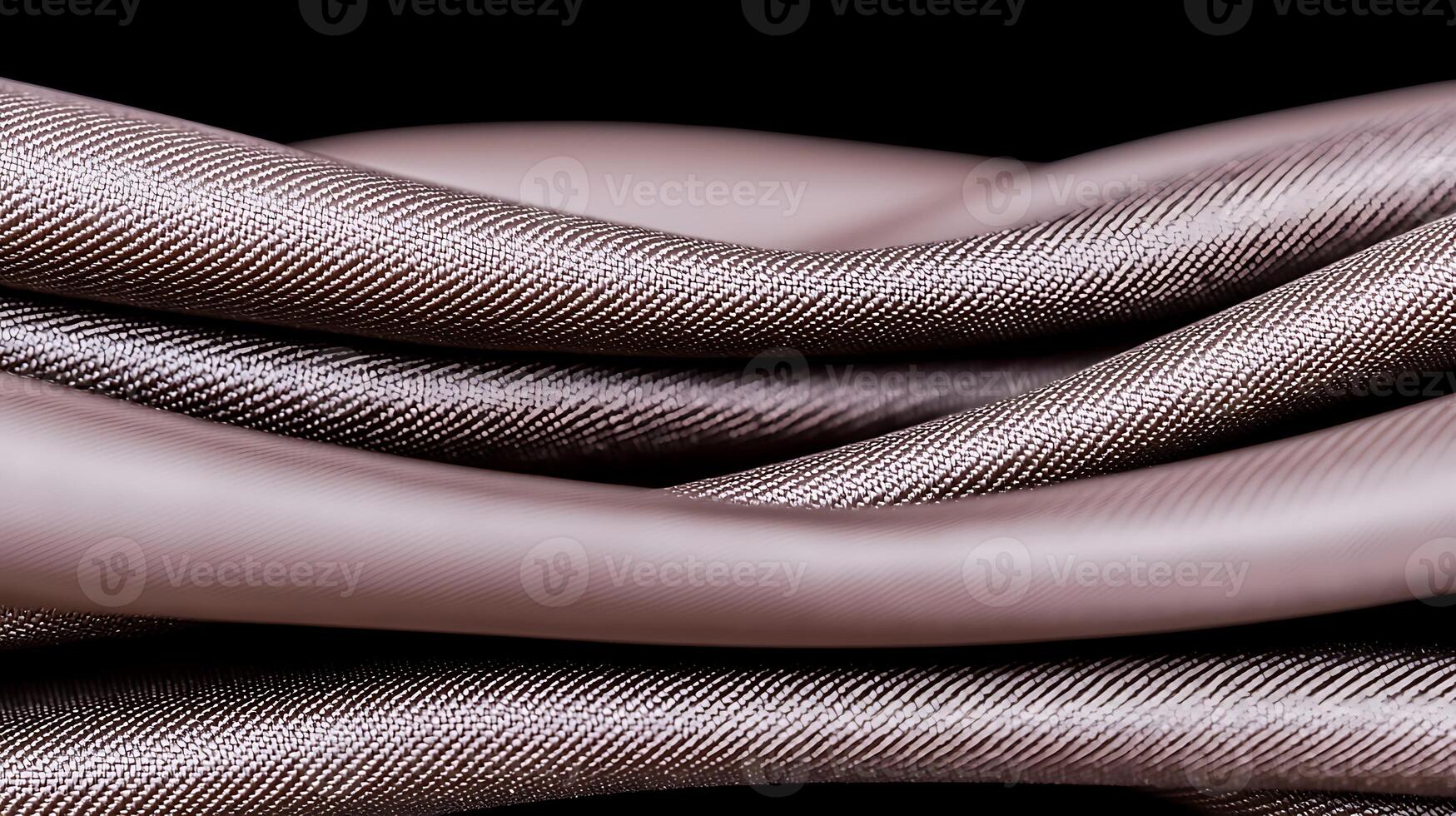 Close-up of intricately woven fabric showcasing smooth, flowing textures against a dark background photo