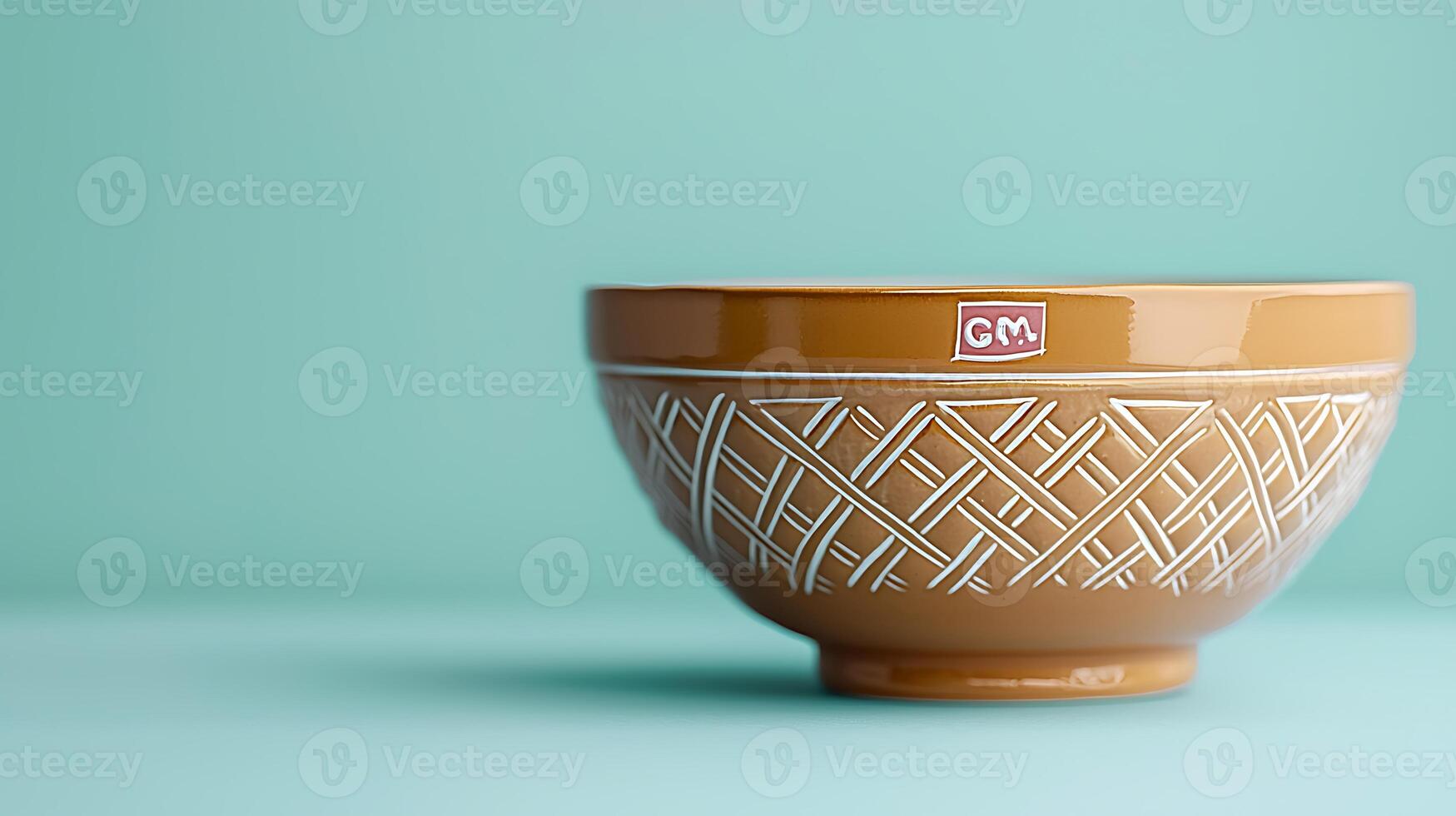 A beautifully crafted ceramic bowl with intricate patterns against a soft teal background photo