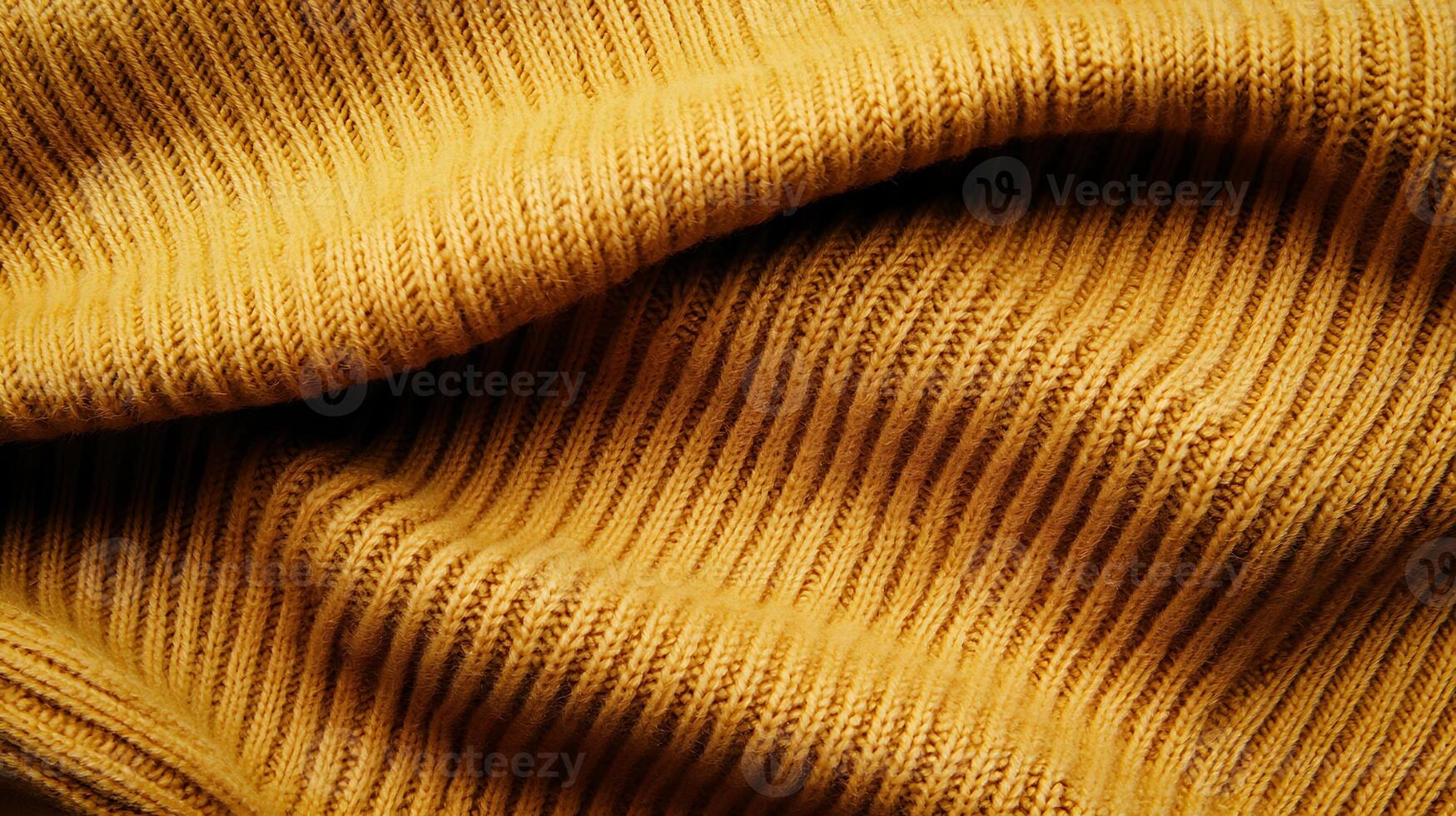 Close-up of textured yellow fabric showcasing intricate ribbed patterns and warm hues photo