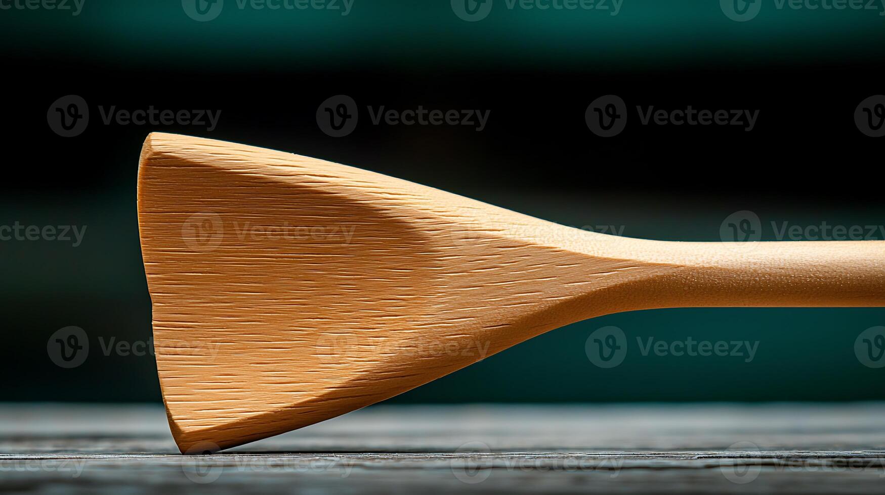 Close-up of a wooden cooking spoon resting on a rustic table with a blurred background photo