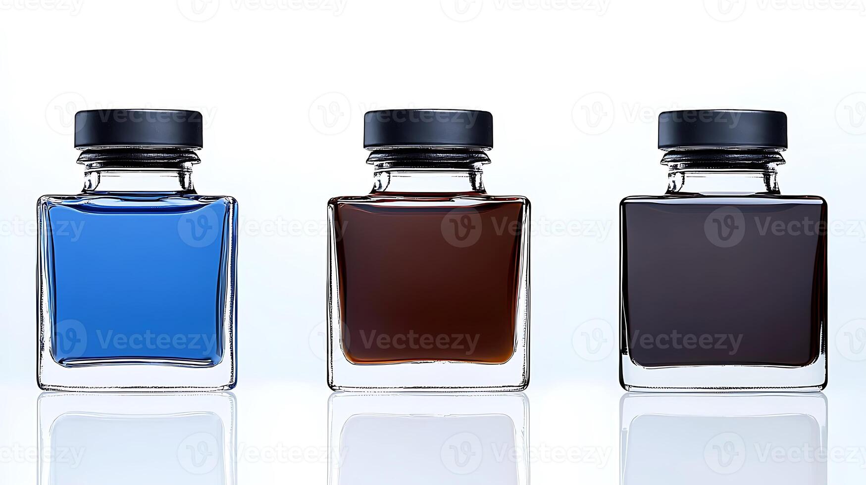 Three glass ink bottles in vibrant blue, brown, and dark brown colors on a reflective surface photo