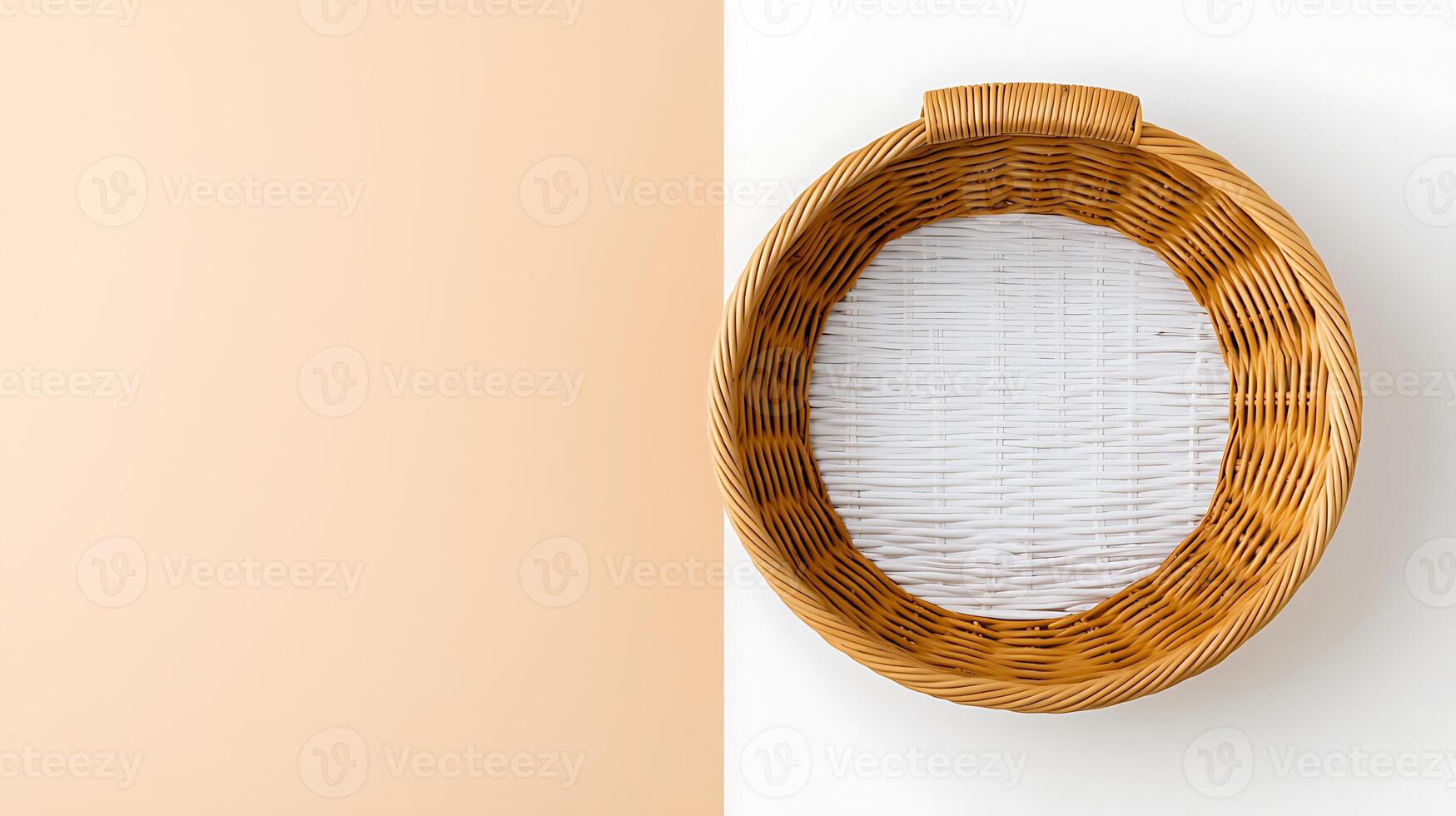 Top view of a round wicker basket with a white interior on a soft peach background photo