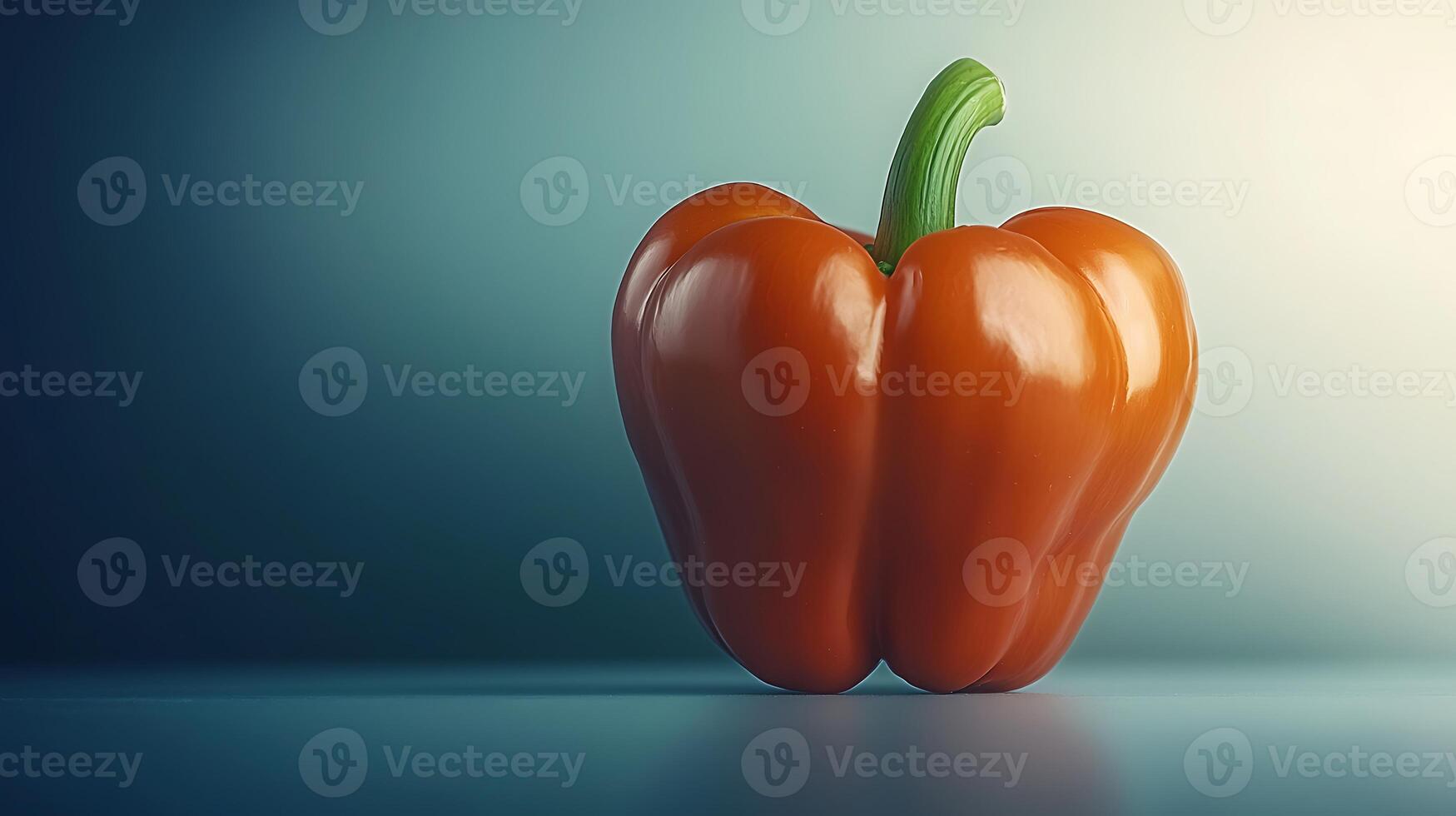 Vibrant orange bell pepper on a smooth surface with a soft gradient background photo