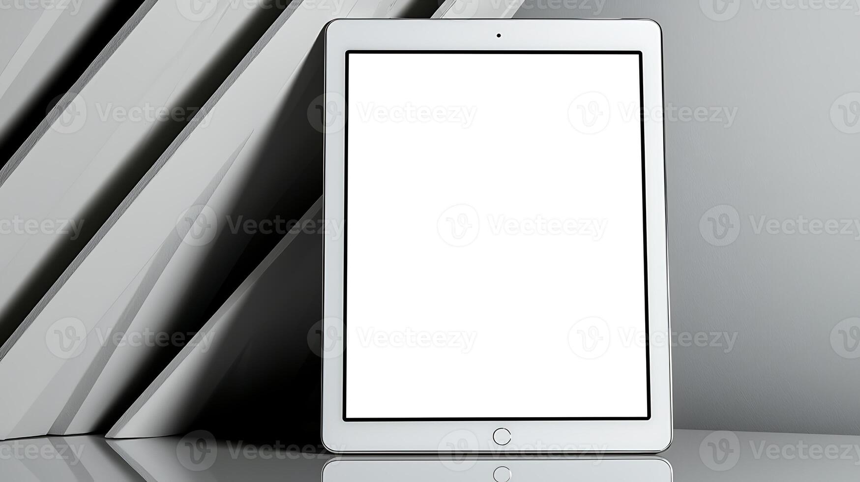 A sleek tablet displayed on a minimalist surface with books in the background, emphasizing technology photo