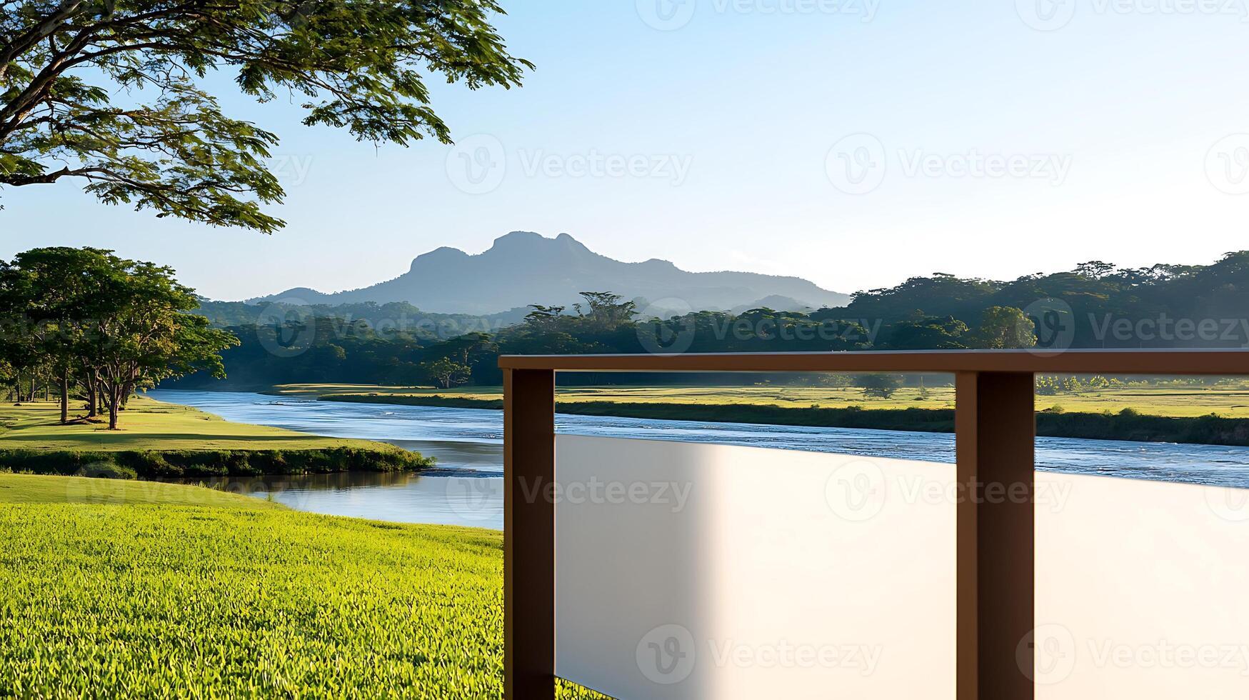 Scenic view of a river with mountains in the background, framed by a wooden railing at sunrise photo