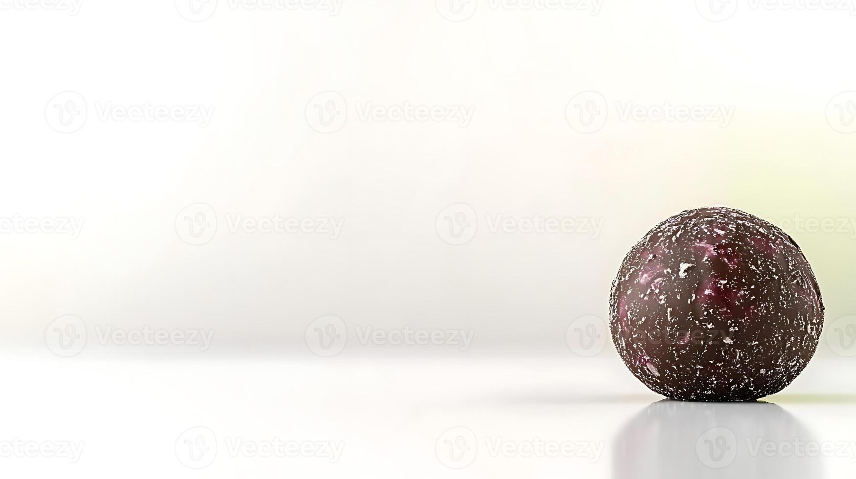 A close-up of a textured chocolate truffle resting on a smooth surface with a soft background photo