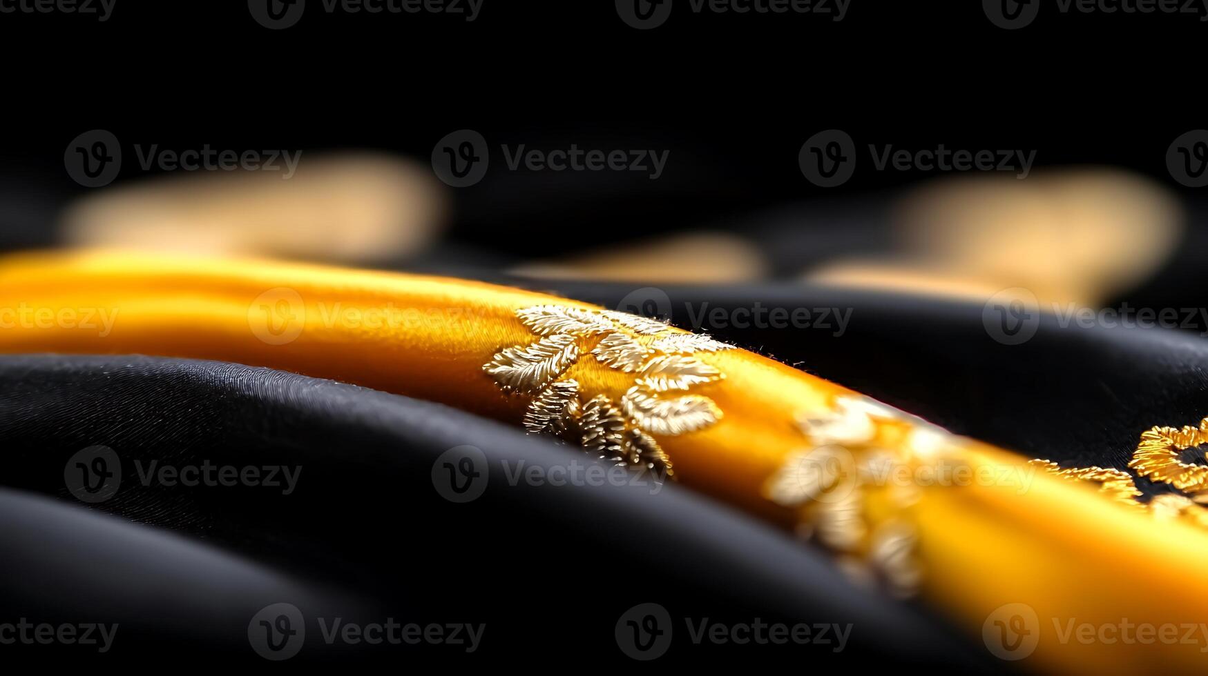 Close-up of luxurious black and gold fabric with intricate embroidery and soft draping photo