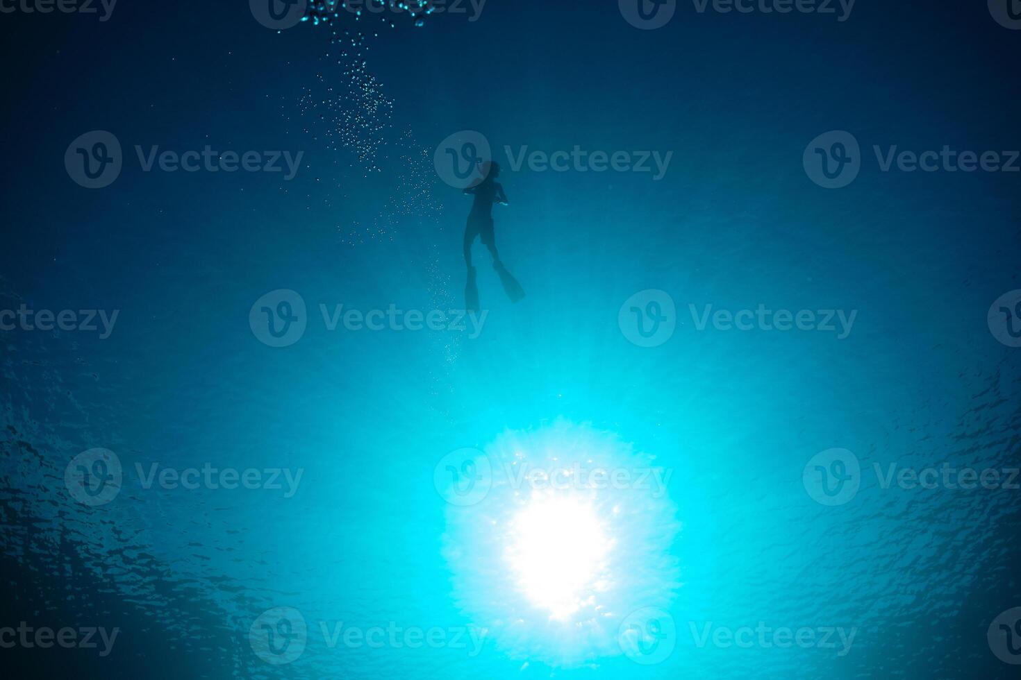 Unrecognizable boy diving in blue sea photo