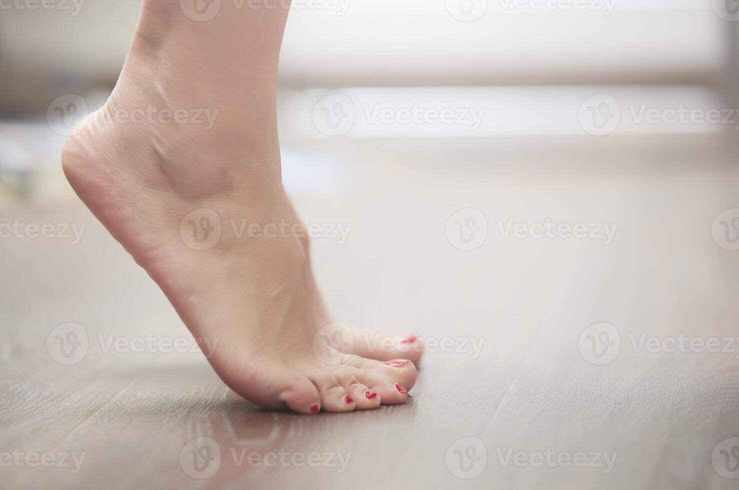 Woman standing on tiptoe photo