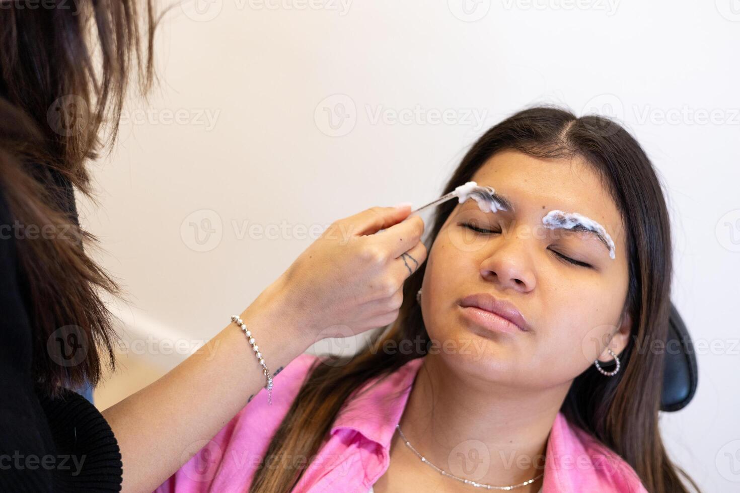 Beautician making eyebrow design and lamination procedures looks easier photo