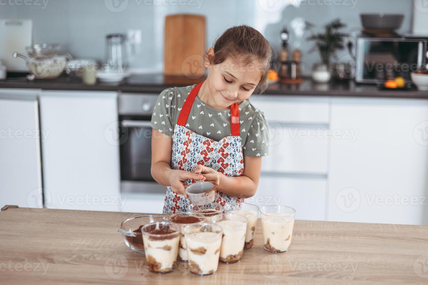 tiramisu making process in the kitchen- little girl making Italian desert with cocoa and espresso-dipped ladyfingers with mascarpone cream step by step 9 photo