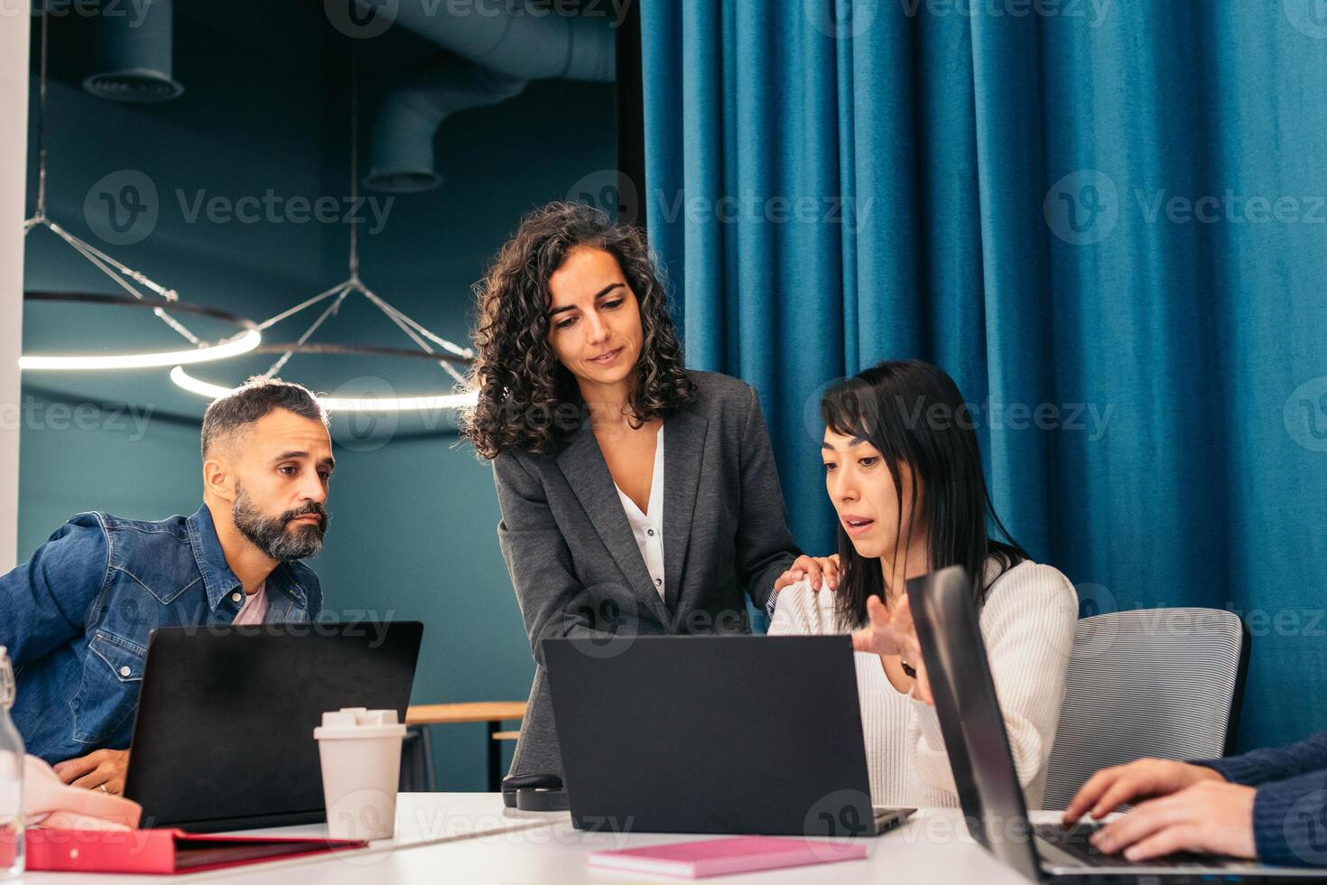 Group of people working with laptop in a coworking space photo