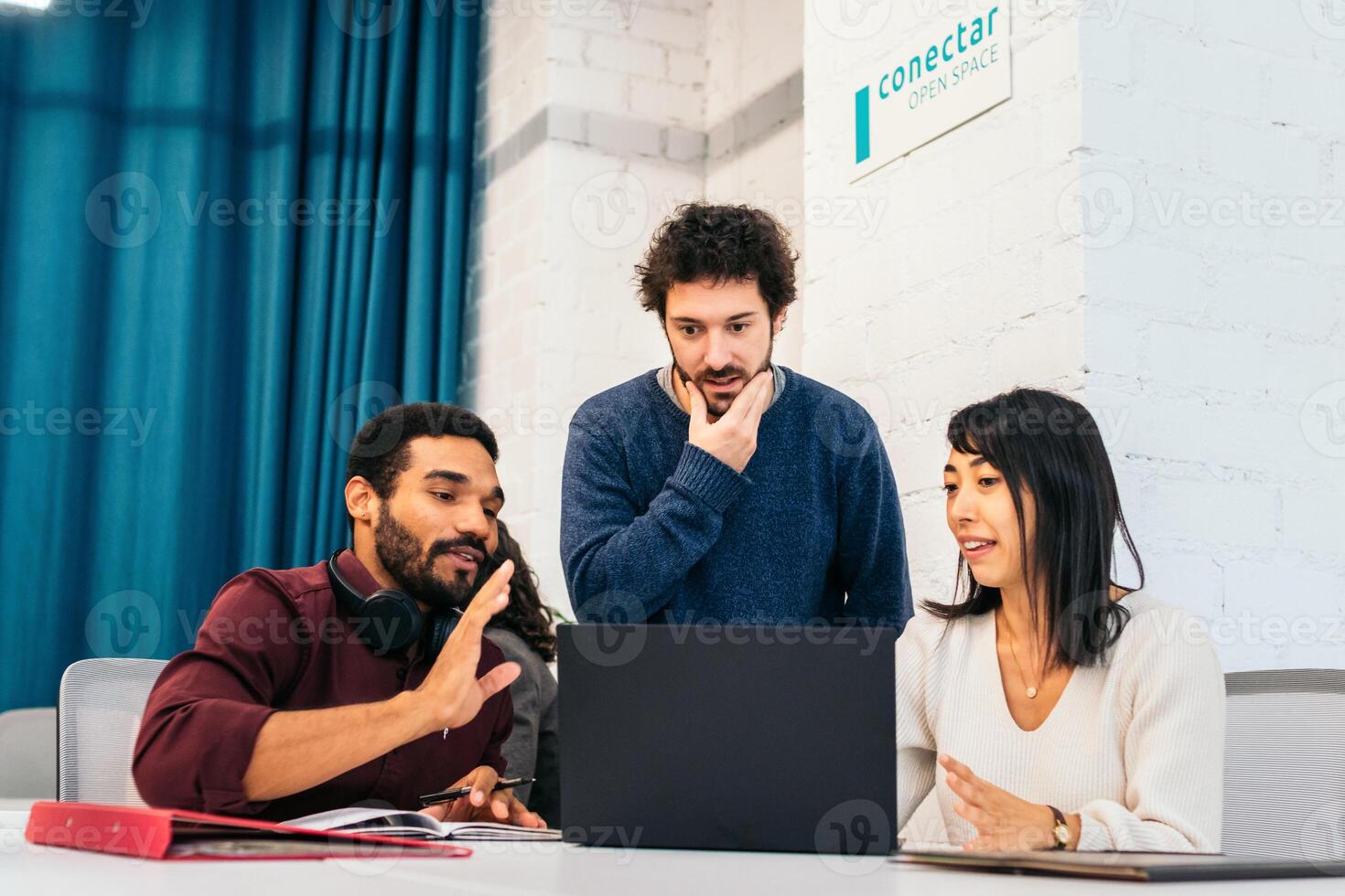 Group of multiracial people working with laptop in a coworking. Teamwork photo