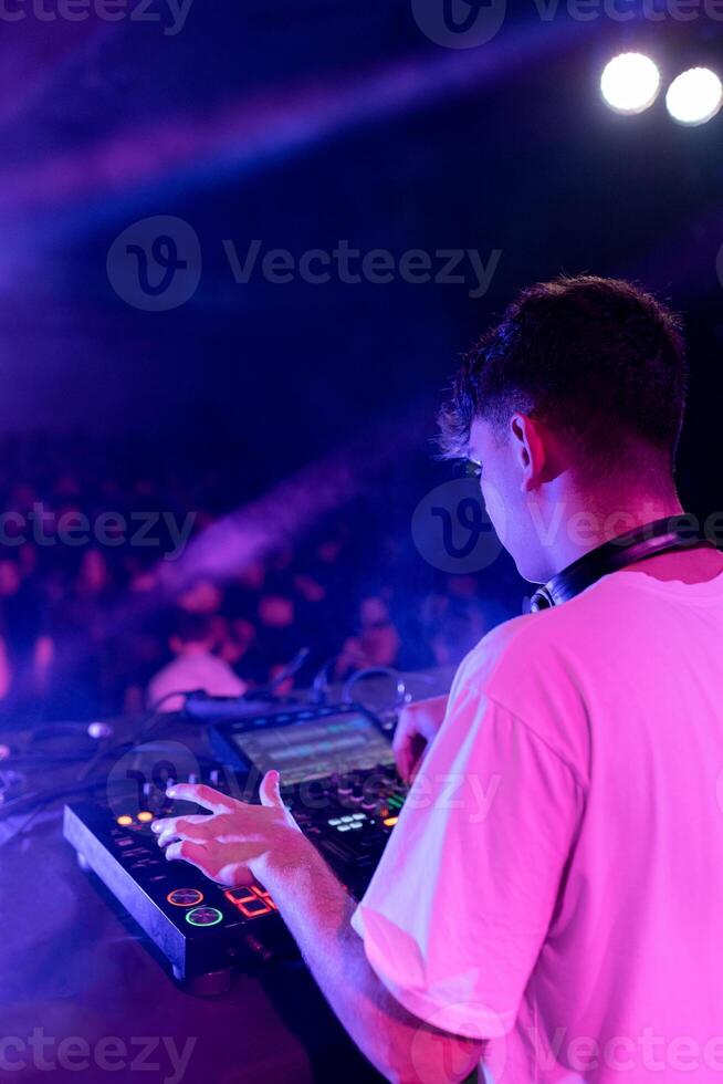 A DJ mixing on stage using board photo