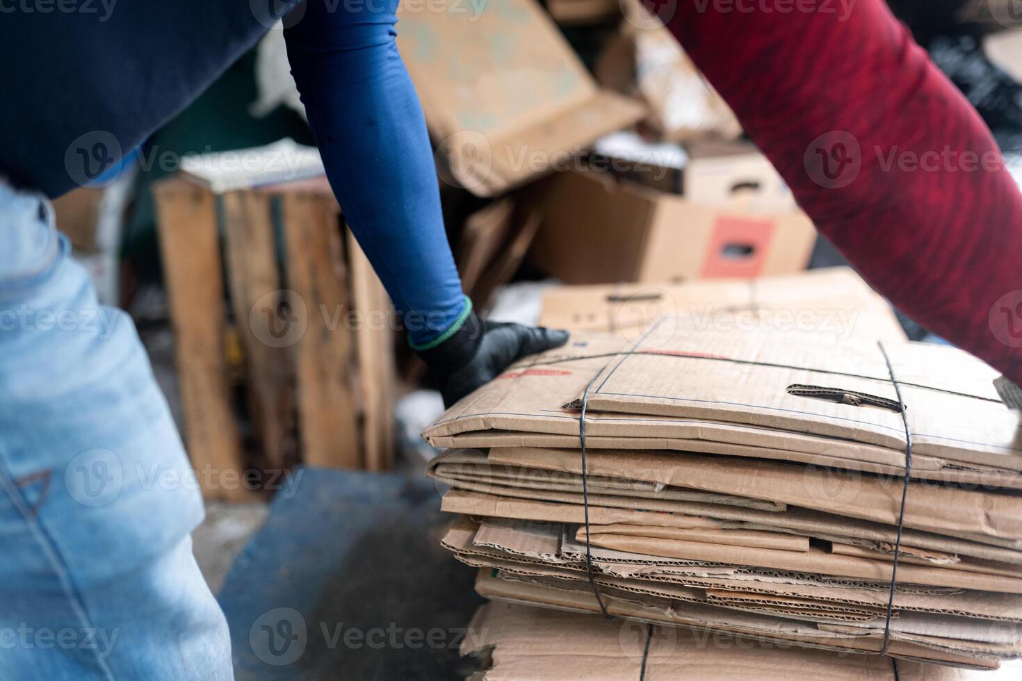 Hispanic Man's Hands Measuring Cardboard in Recycling Facility. Close Up photo