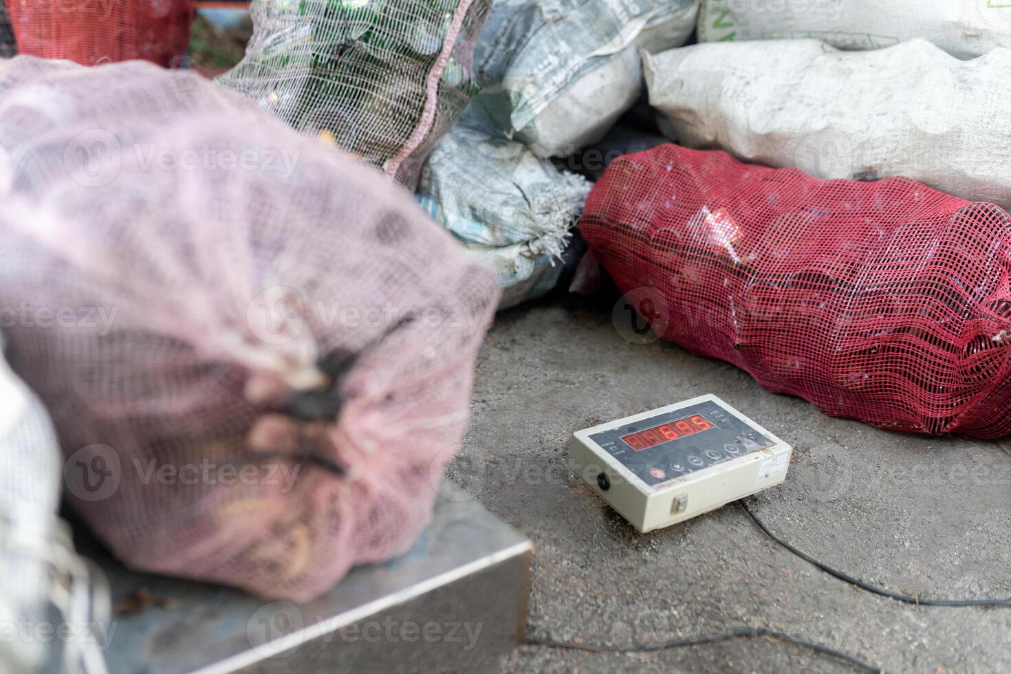 Digital Scale Weighing Recycled Glass Bottles. Close up photo