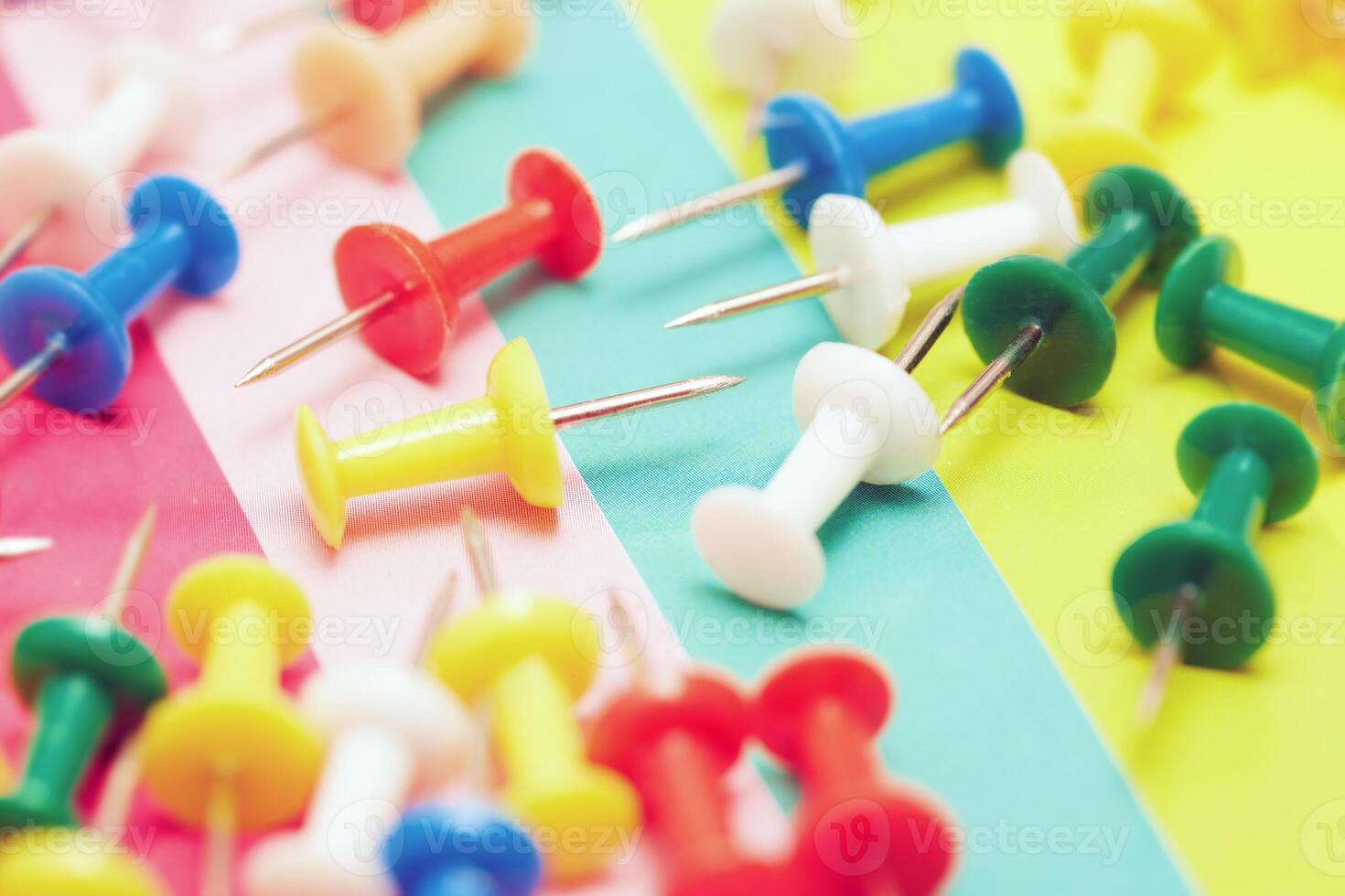 Colorful pushpins with colorful background photo