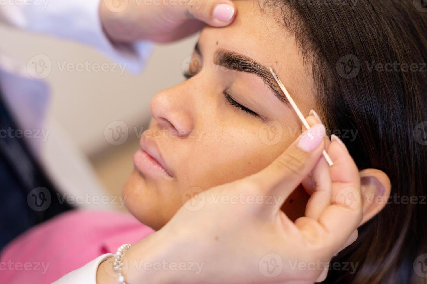 Beautician making eyebrow design. Beauty concept photo