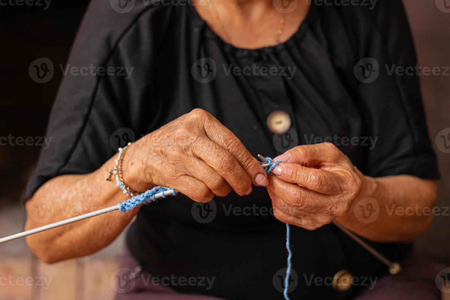 Weaving tales. Elderly hands knit life's journey. photo