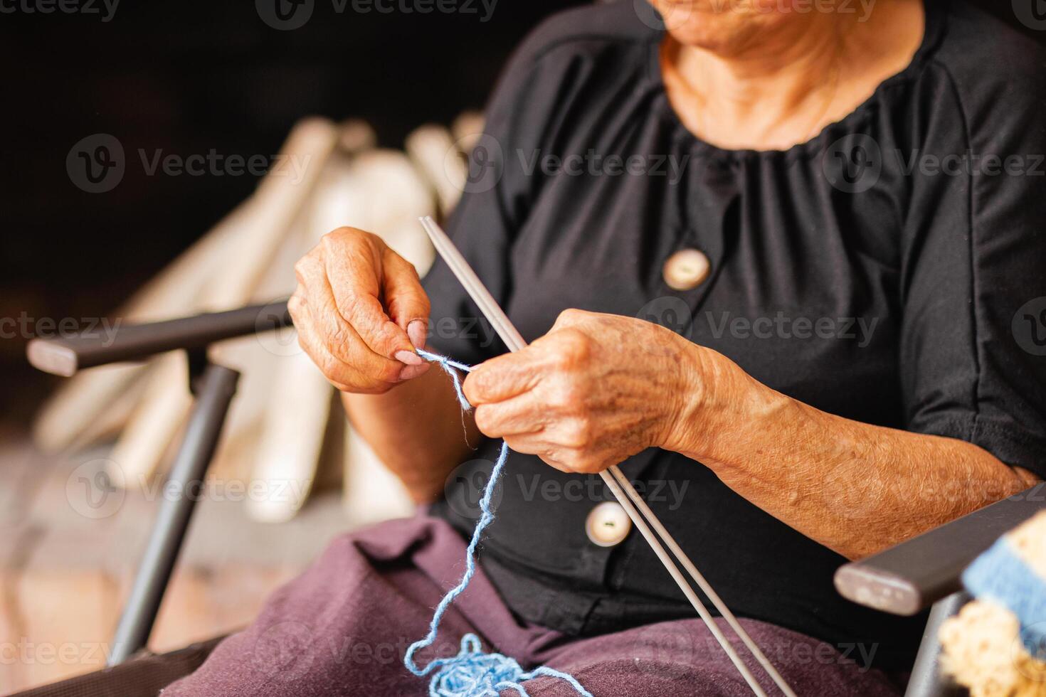 Ageless artistry. Elderly woman weaves yarn with skill. photo