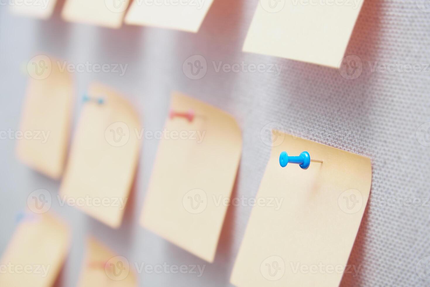 Sticky notes on a bulletin board with pin photo