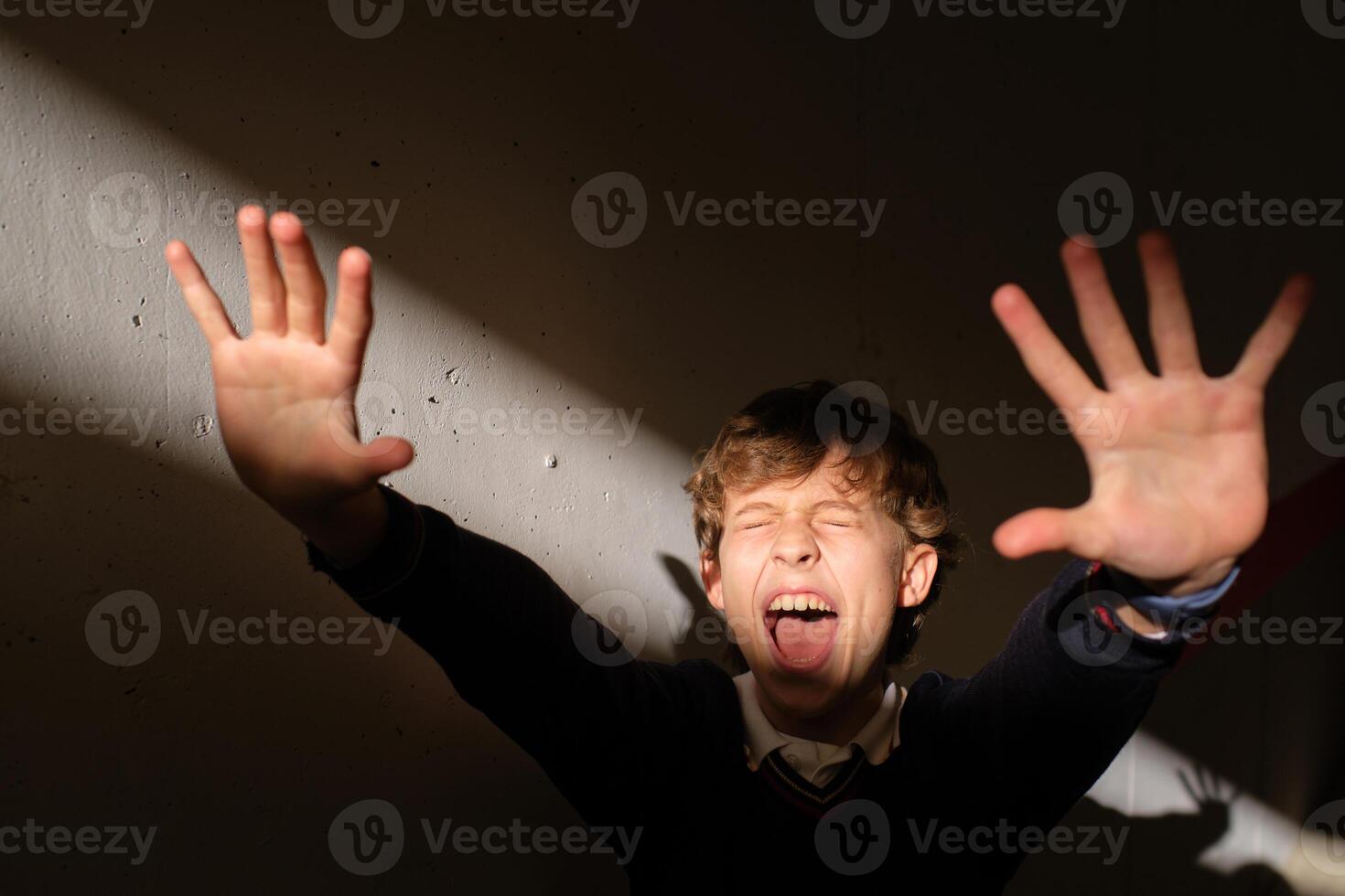 Excited boy screaming and reacting on sudden bright light photo