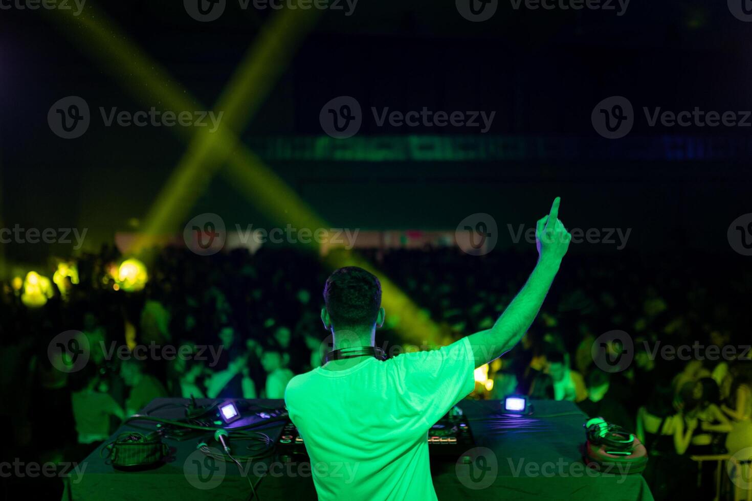 DJ gesturing during a performance in a club photo