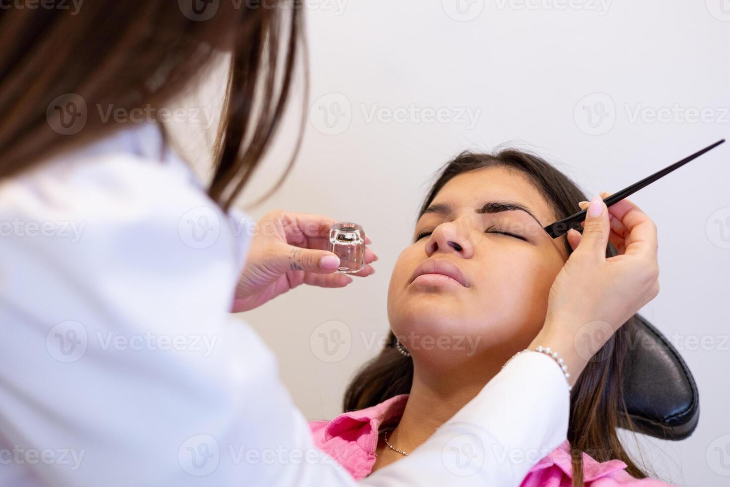 Beautician making eyebrow design and shading procedures. Beauty in art and creativity photo