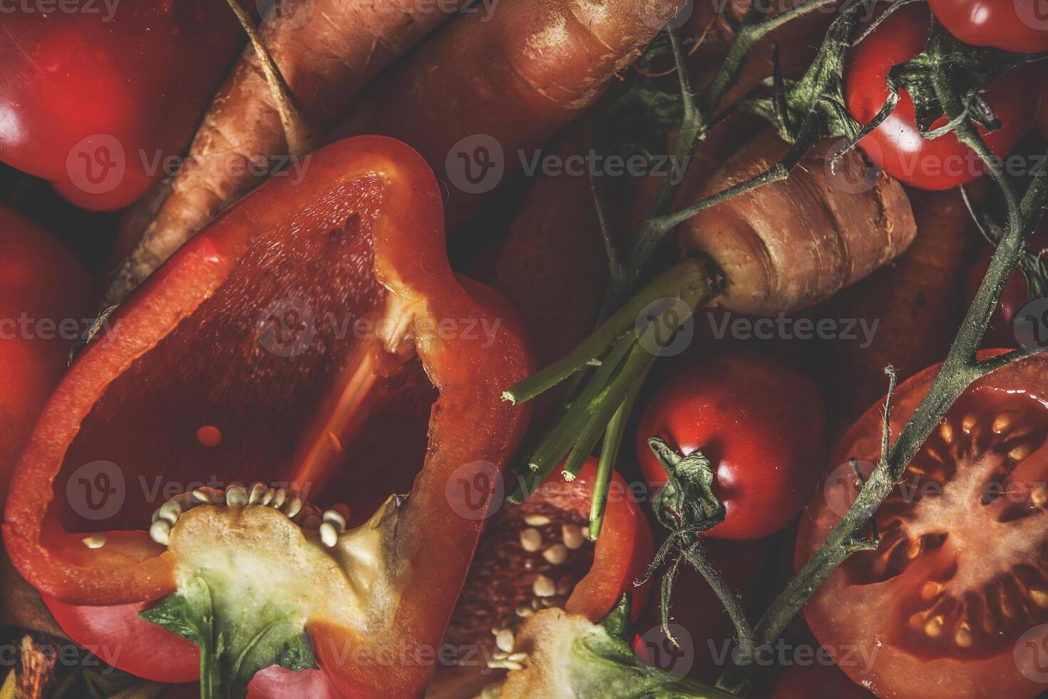 Food background with close up of raw orange and red vegetables bell pepper, carrots and tomatoes. Healthy lifestyle with vitamins rich ingredients. Top view. photo